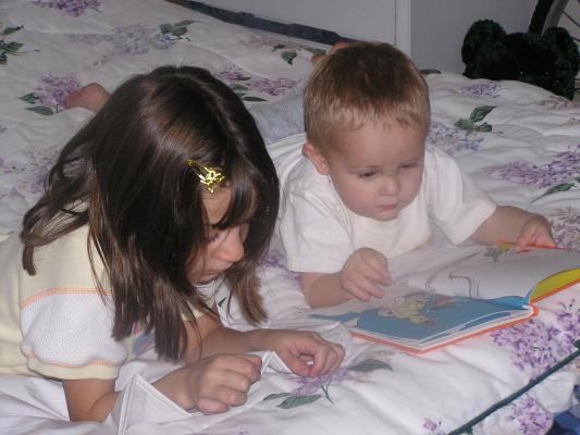 Andrea and Noah read a book together.