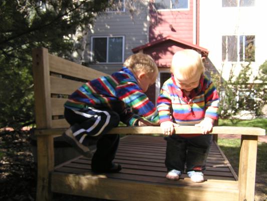 Noah and Sarah climb on the bench.