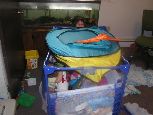 Andrea helps burry Noah in toys.
