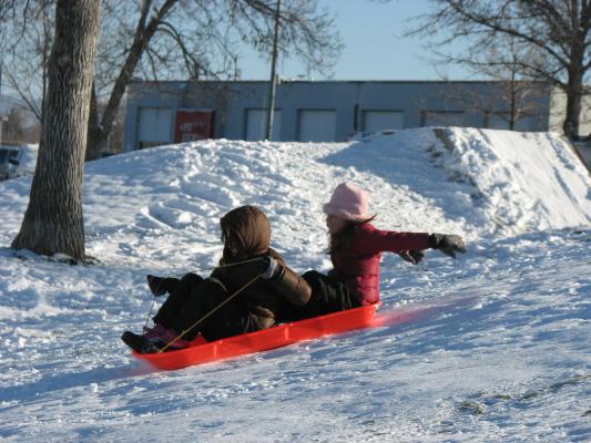 Malia and Andrea sledding.