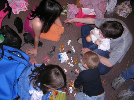 The kids play with the animals.