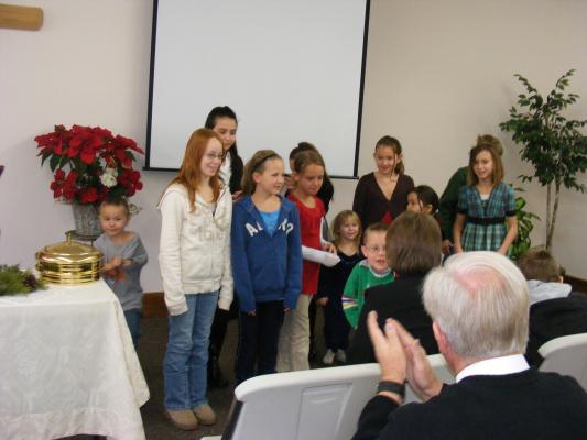 children finish song at church.