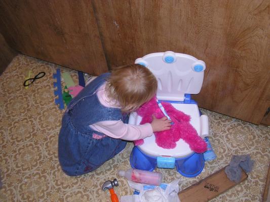 Sarah brushes the bears teeth