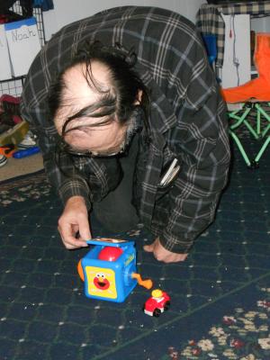 Grandpa Eder plays with the Jack-in-the-box. 