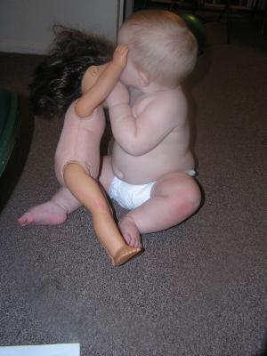 Sarah plays with a doll.