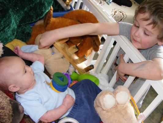 Noah got all the baby toys for Joshua to play with.