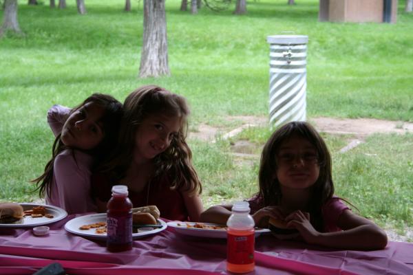 Malia, Nicole and Andrea eat some hamburgers and hotdogs.