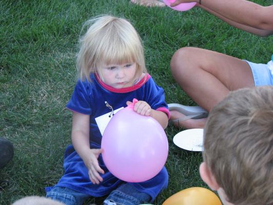 Sarah at game with a pink balloon