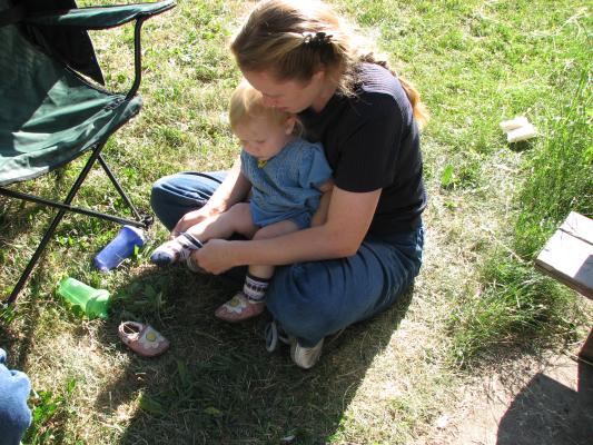 Sarah gets her socks on with her Mom, Katie's, help.