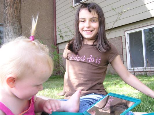 Sarah and Malia play with hair.