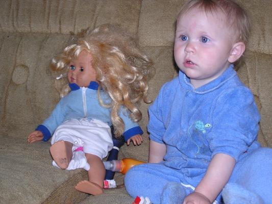 Sarah watches some Elmo with her two toothbrushes.
