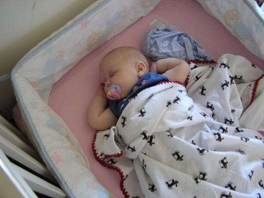 Sarah sleeps in her crib.