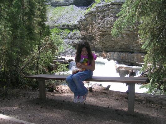 Andrea sits on a bench.