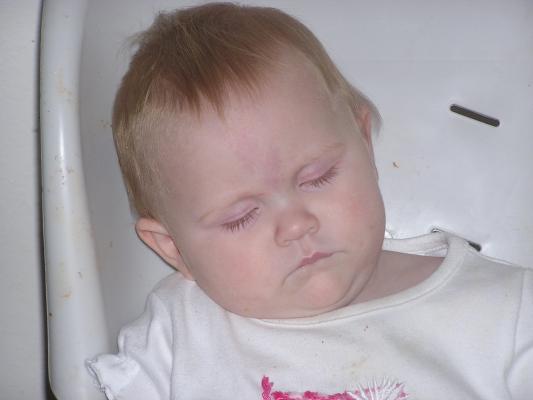 Sarah sleeps in her highchair.
