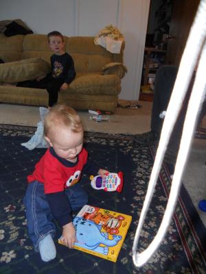 Joshua with his phone and his book. 