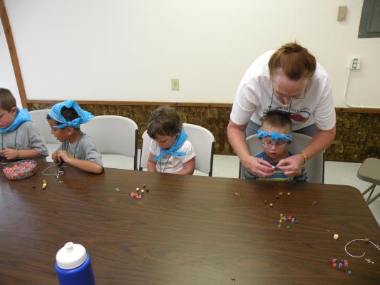 Kathy helps Noah with a few beads.