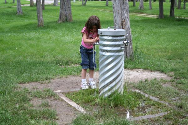 Andrea plays with the water fountain.