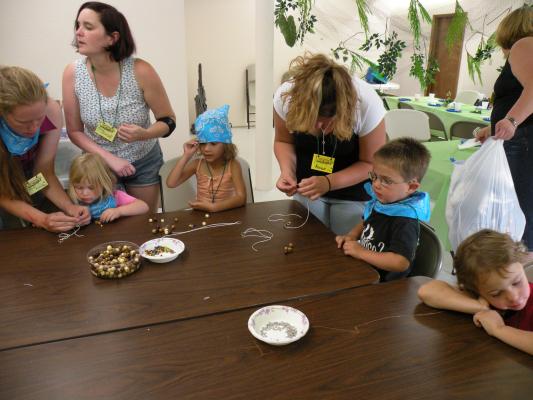 Blue Sprouts working on stringing beads.