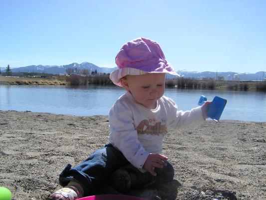 Sarah shovels some sand.