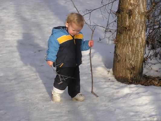 Noah is happy to have two sticks to play with, but he is starting to feel a little cold.