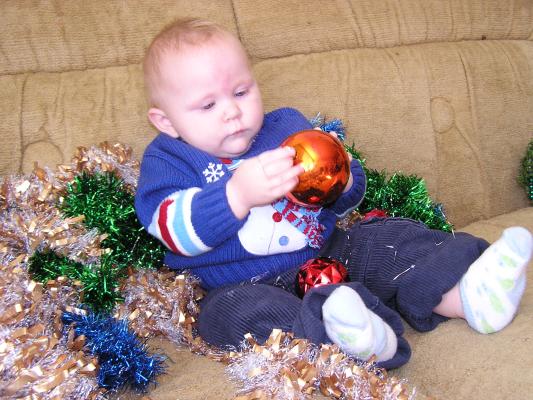 Sarah plays with a big Christmas Ball.