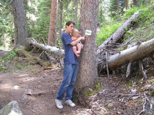 David shows Noah the trail sign.