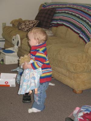 Sarah plays with a baby doll.