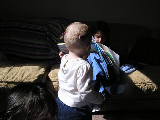 The back of Sarah's head with two ponytails. 
Andrea looking at a book. 
The top of Malia's head.