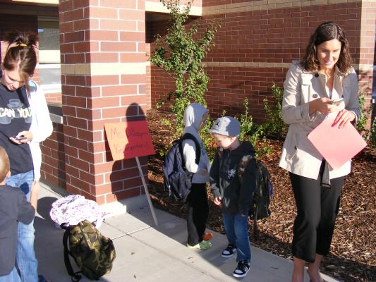 Ms. DiProspero lines up Noah and another Kindergärtner.