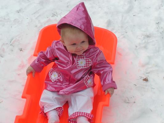 Sarah is having fun in the sled.