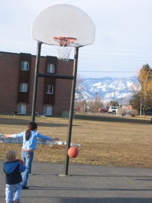 Malia and Noah play basketball.