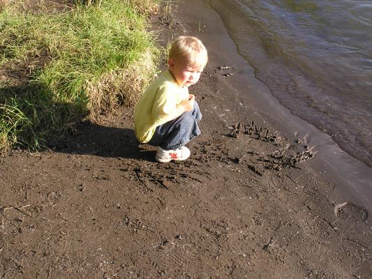 Noah draws in the sand on the bank of the Yellowstone River.