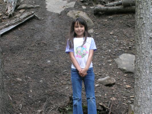 Malia in front of a bunch of broken rocks.