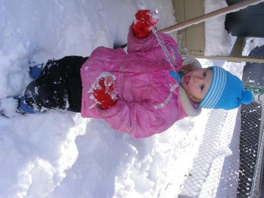 Sarah eats an icicle.