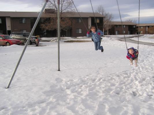 Malia and Sarah on the swings.