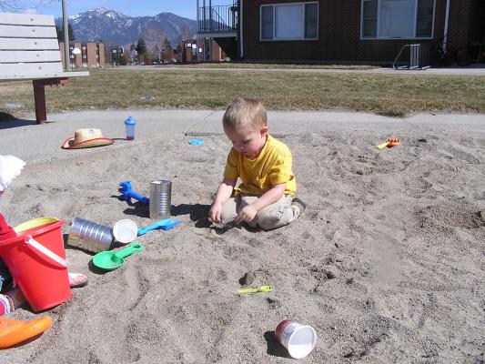 Noah finds a toy car in the sand.