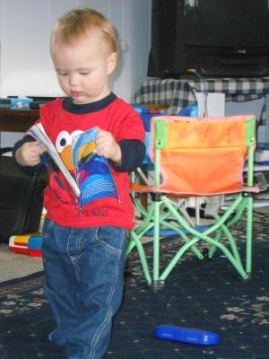 Joshua reading Noah's book from the book fair at school. 