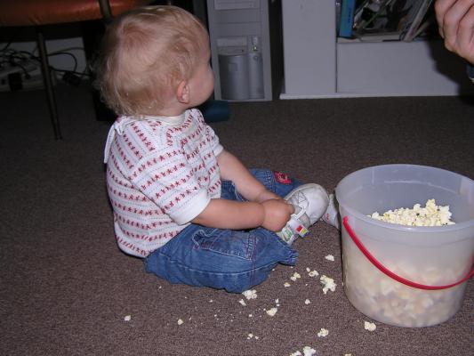 Noah eats some popcorn.