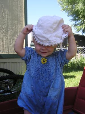 Sarah in the wagon with a hat