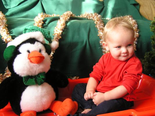 Noah and his penguin are ready to go for a ride.