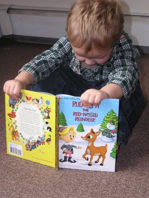 Noah reads Rudolf the Red Nosed Raindeer.