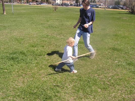David and Noah play in the grass.