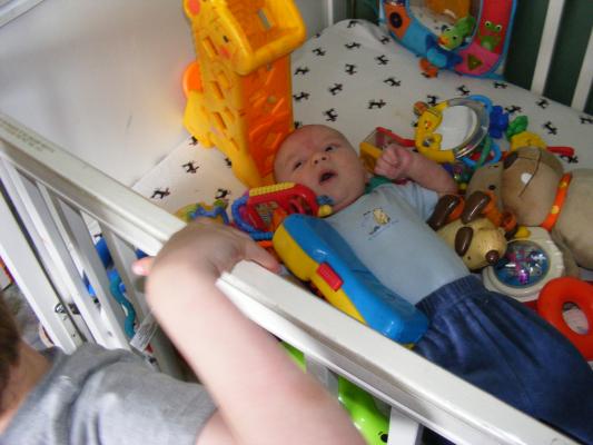 Noah got all the baby toys for Joshua to play with.