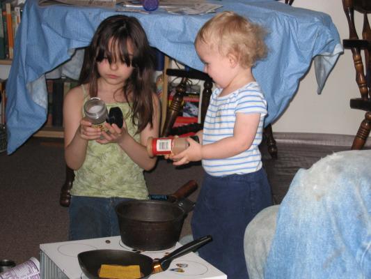 Malia and Noah play cooking with spices.