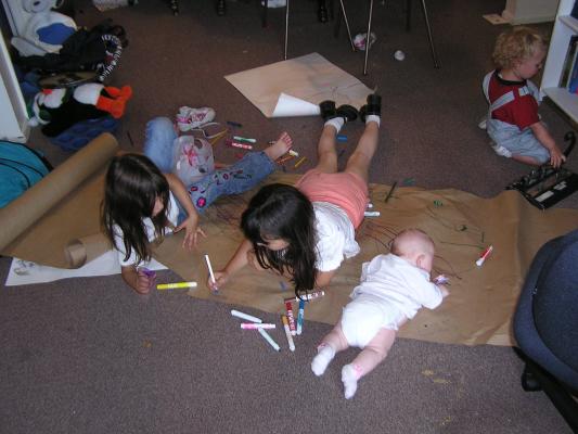 Andra, Malia and Sarah color. Noah is distracted by the hole punch.