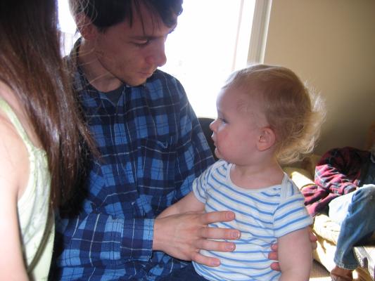 Noah sits on daddy's lap.
