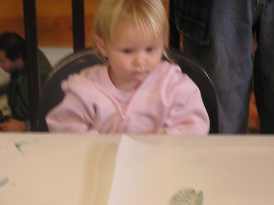 Sarah eats her candy by the bird stamps