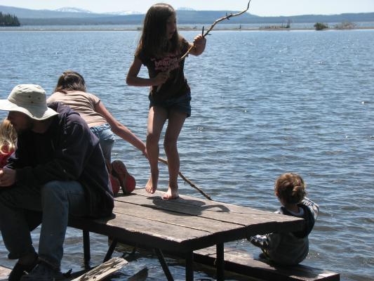 Playing fishing on picnic table.