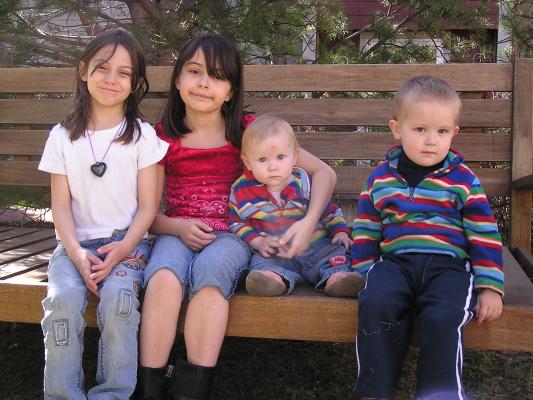 Andrea, Malia, Sarah and Noah on the bench; portrait.