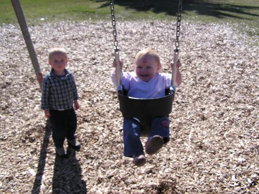 Sarah swings at the park.